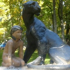 Statue of Mowgli, Priozersk, Russia - Front right, mottled sunlight Statue of Mowgli, Priozersk, Russia - Front right, mottled sunlight